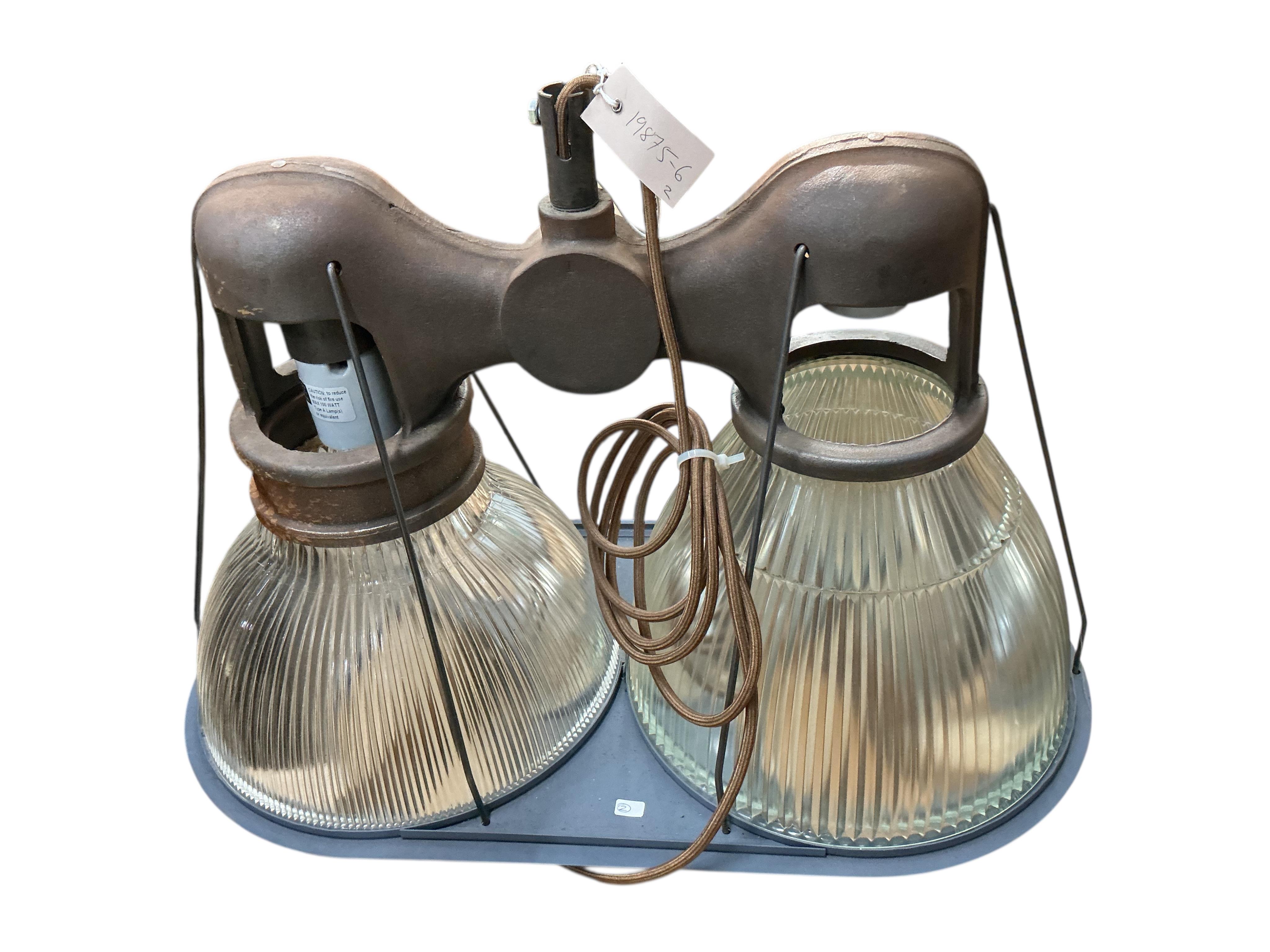 A pair of Holophane double industrial factory lights, width 64cm, height 42cm